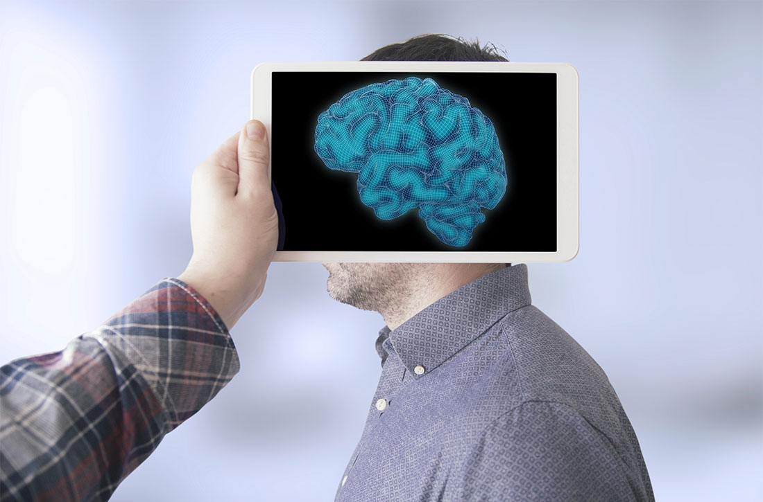 Hand holding image of brain over man's profile