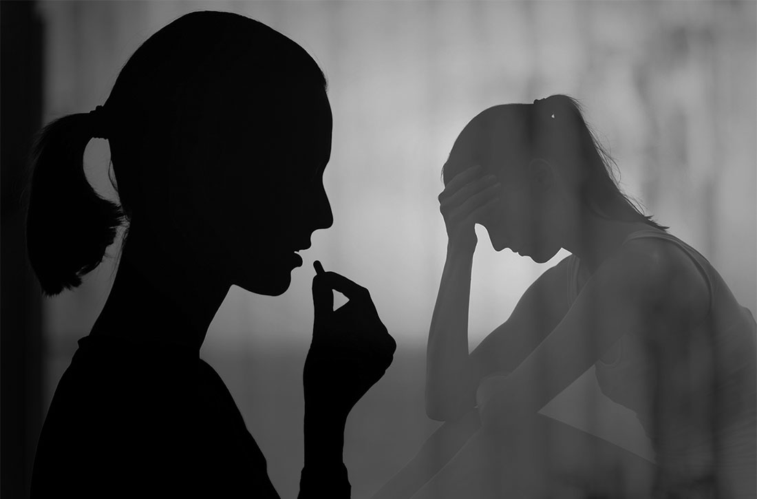 Shadow of woman taking pill next to shadow of woman sitting down holding her head