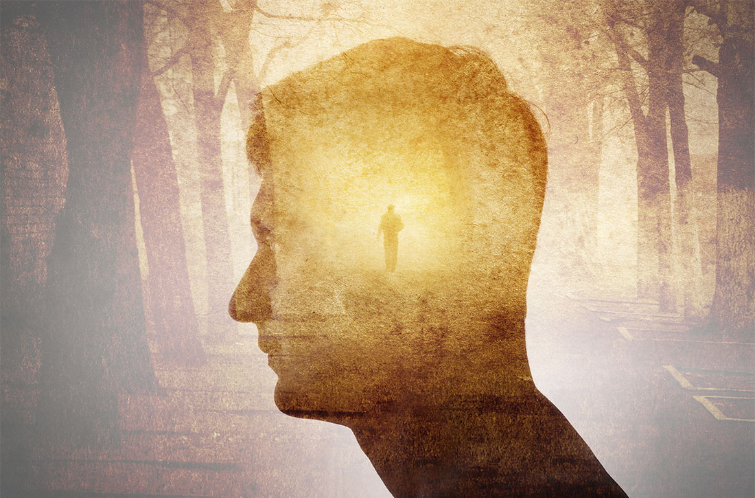 Man's head over background of man in forest