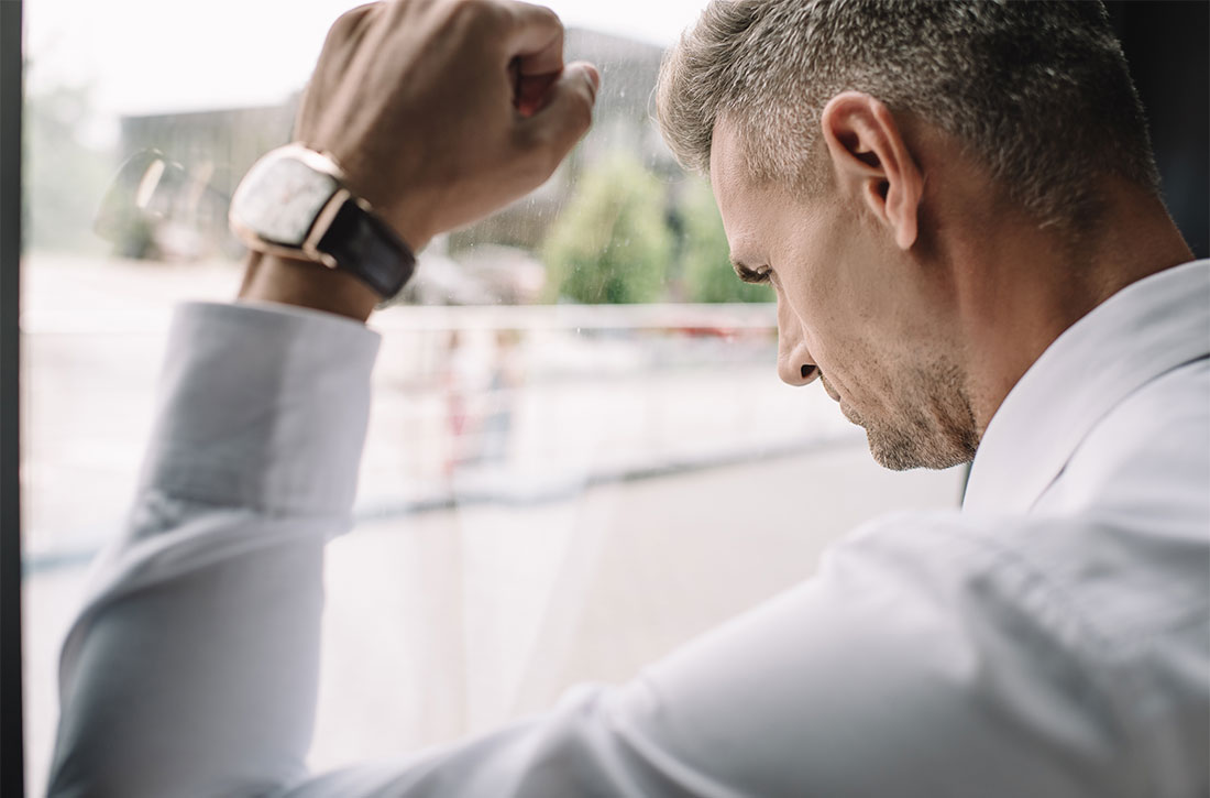 Man leaning up against window with fist