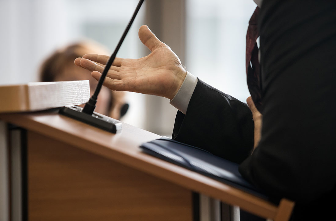 Man standing at podium with mic