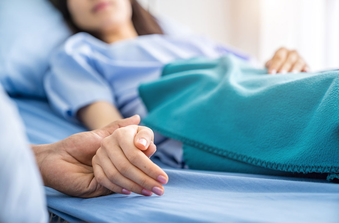 Holding patient's hand