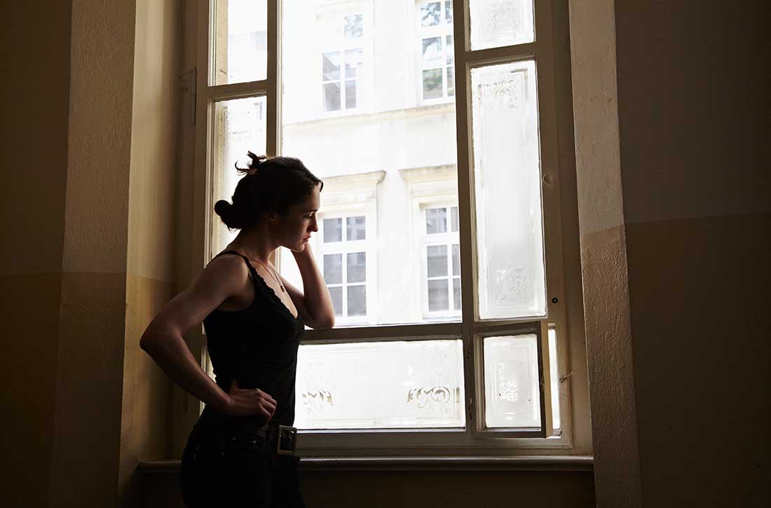 Woman looking out window