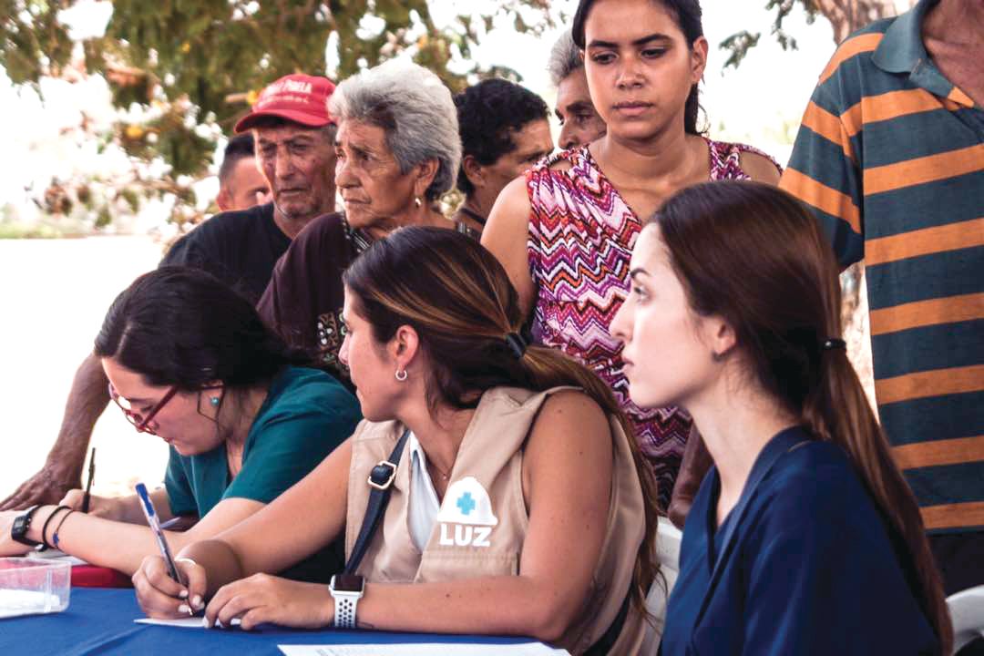 Patients wait in line to be seen during a medical visit in San Luis, Maracaibo, by the nongovernmental organization Primeros Auxilios LUZ.