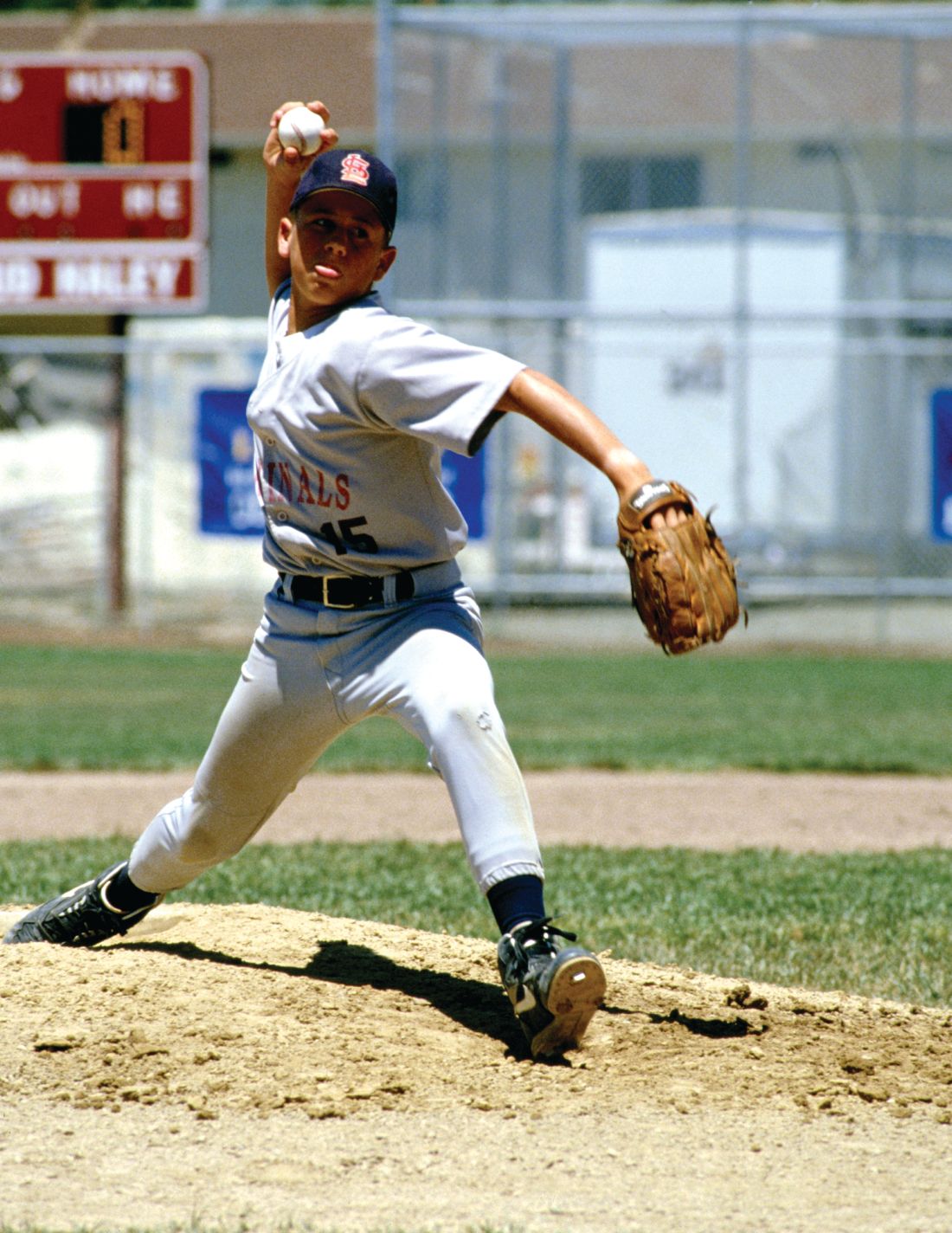 A young baseball player delivers a pitch