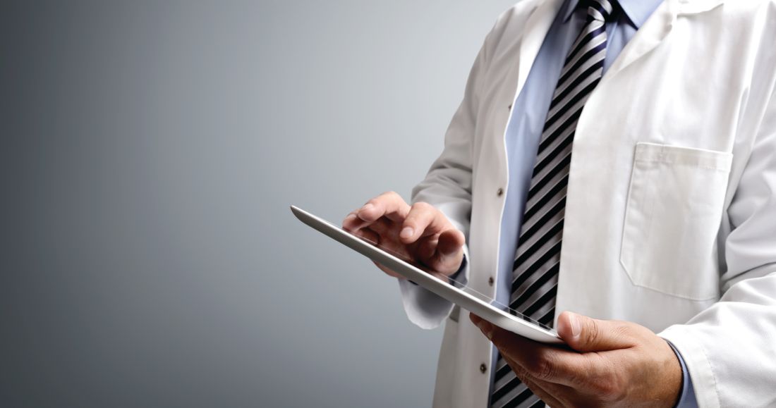 A doctor holds a tablet