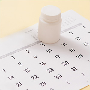 Pill bottle sitting on calendar