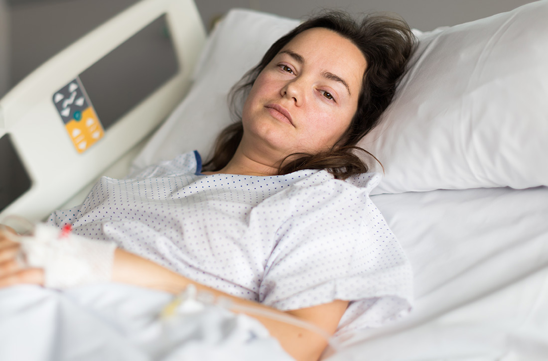 Woman lying in hospital bed