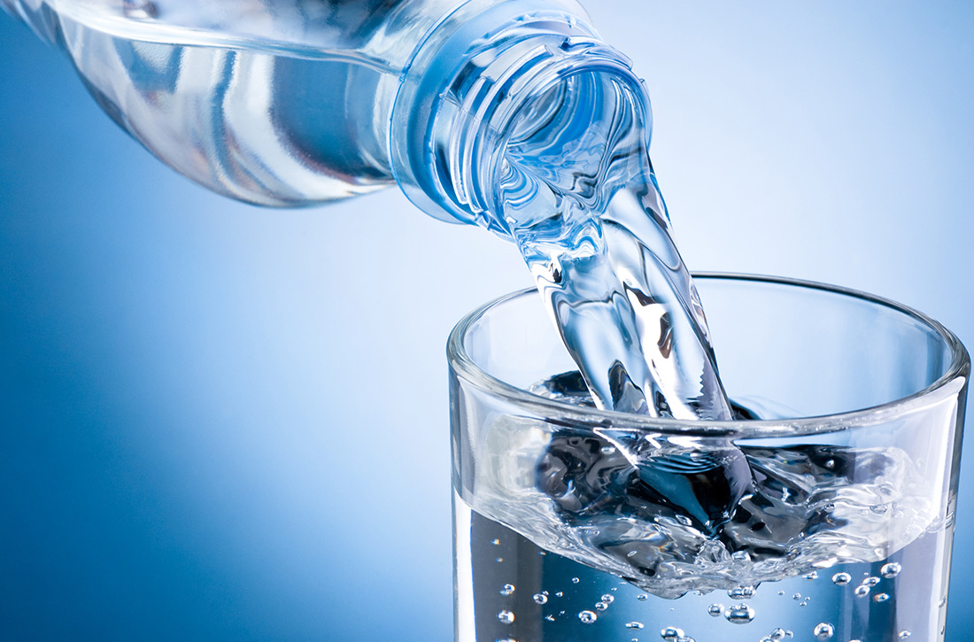 Water being poured from bottle into glass