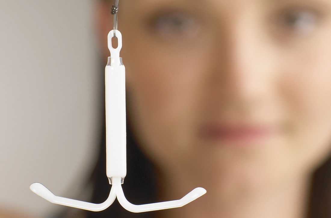 Woman holding IUD