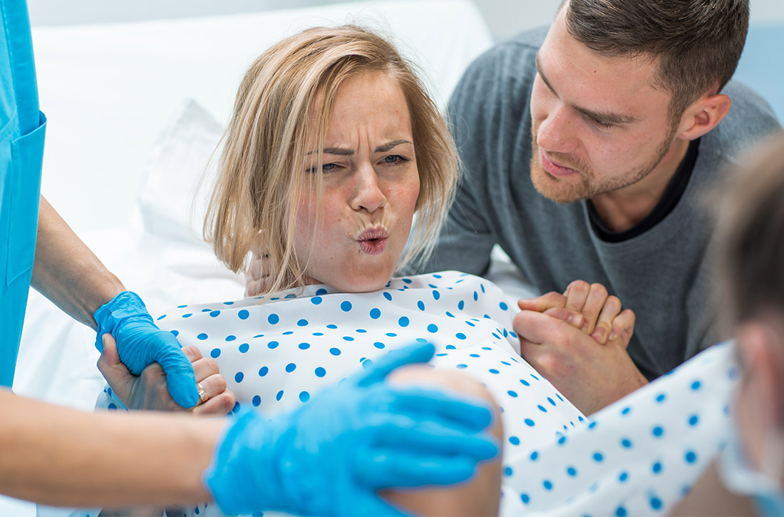 Pregnant woman pushing during labor