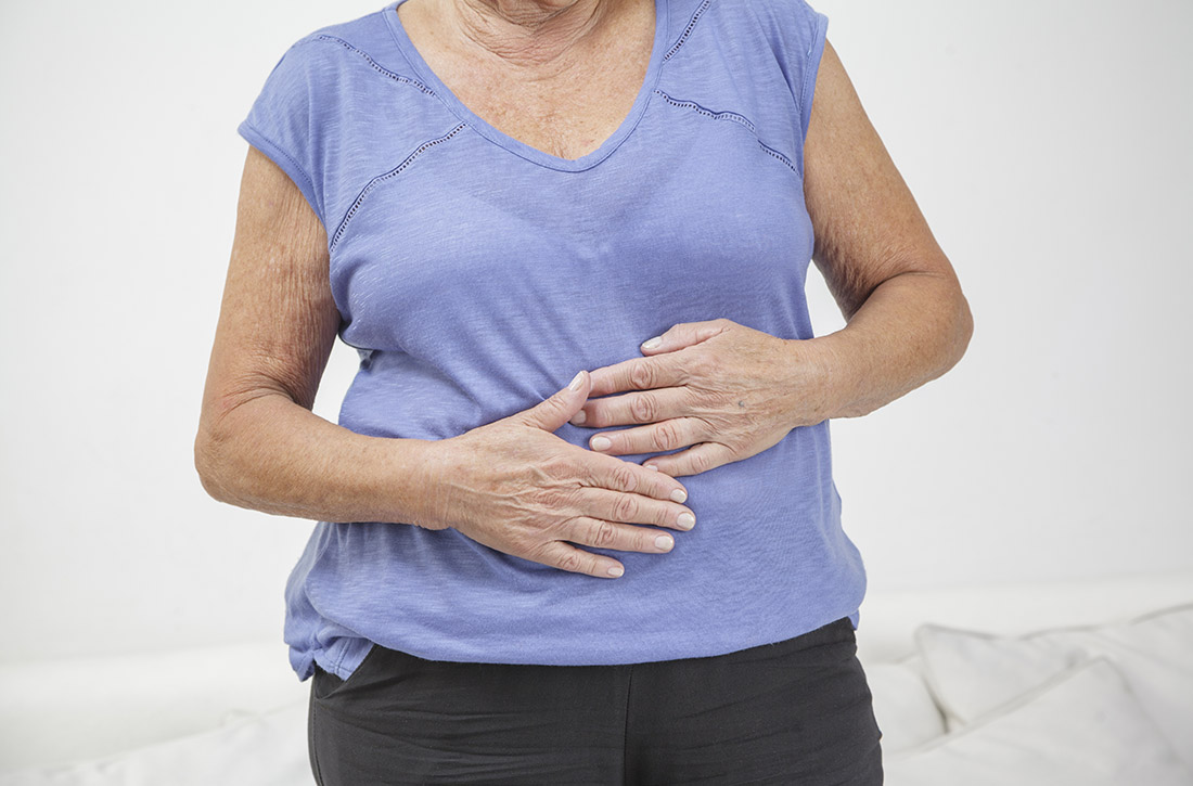 Woman holding stomach in pain