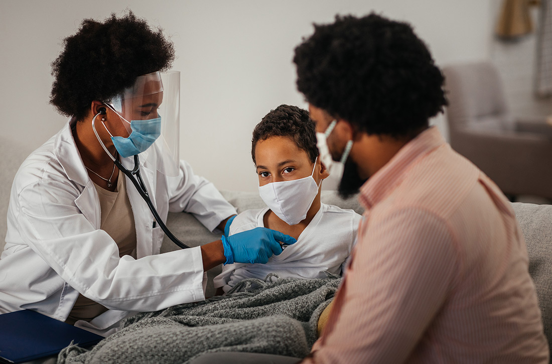 doctor examines patient with adult present