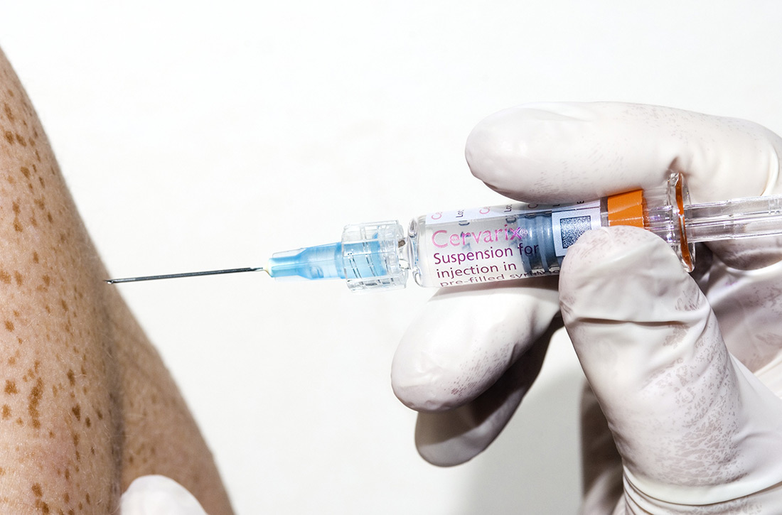 gloved hand giving injection