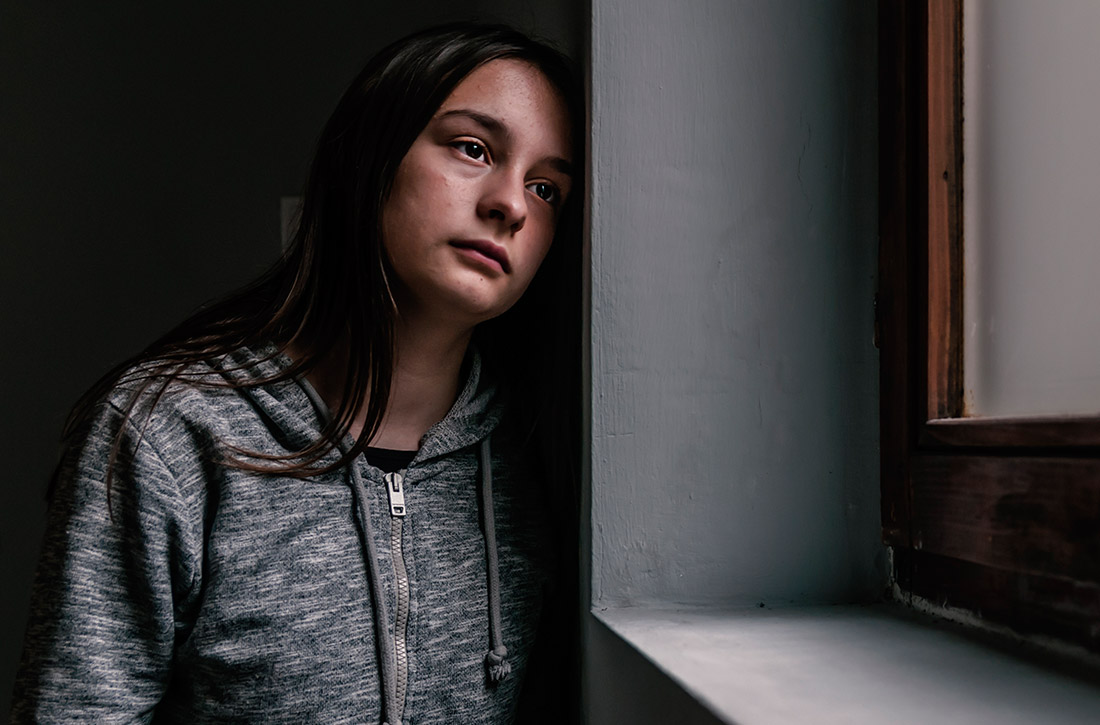 Girl looking out window