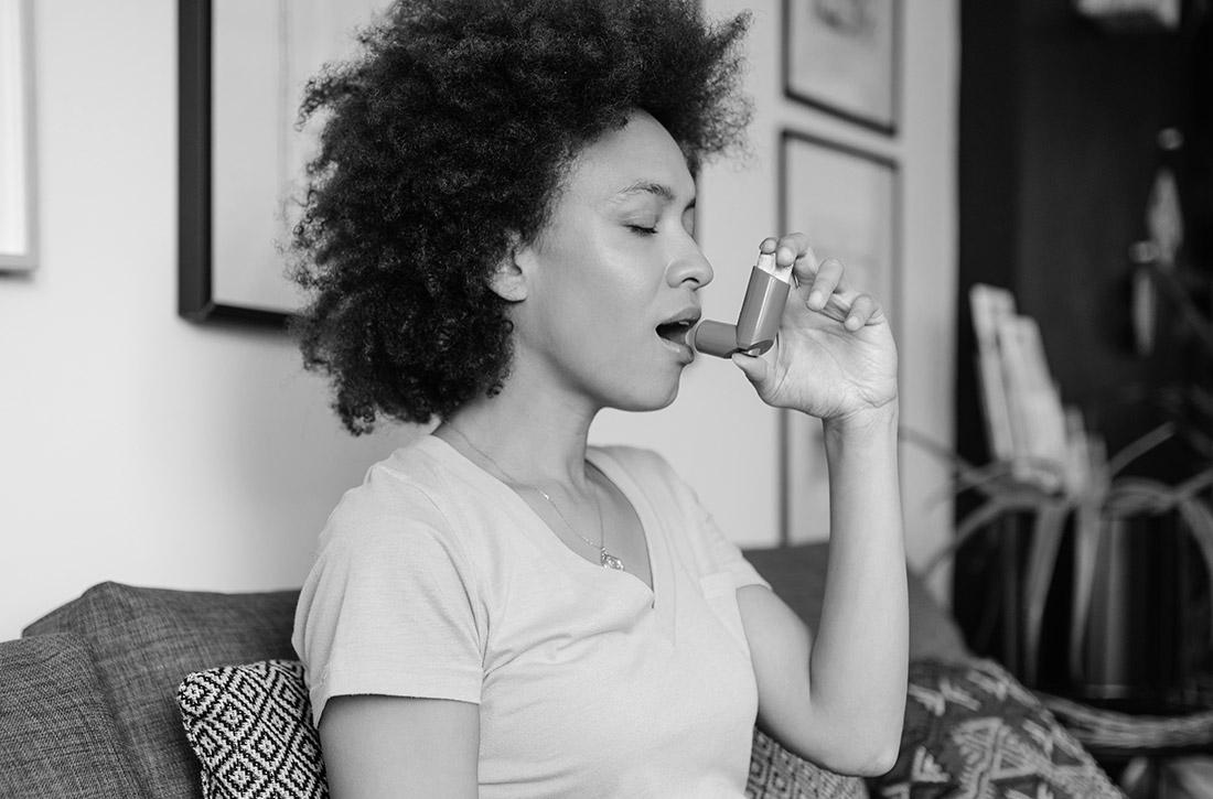 Woman using inhaler