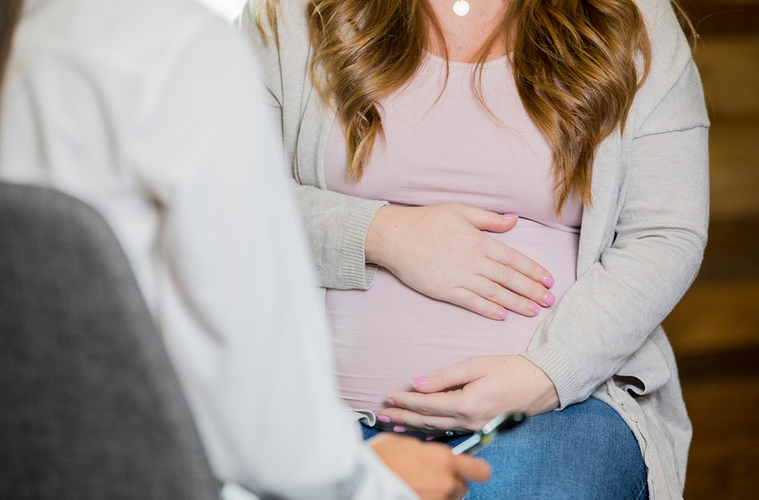 Pregnant woman with doctor