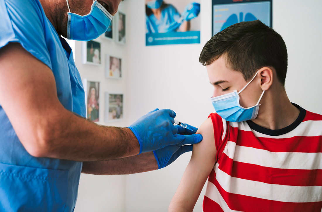 Doctor giving vaccine to patient