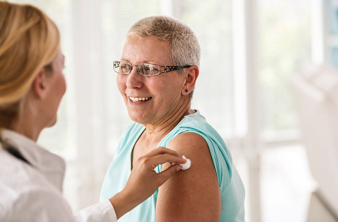 Doctor giving patient vaccine