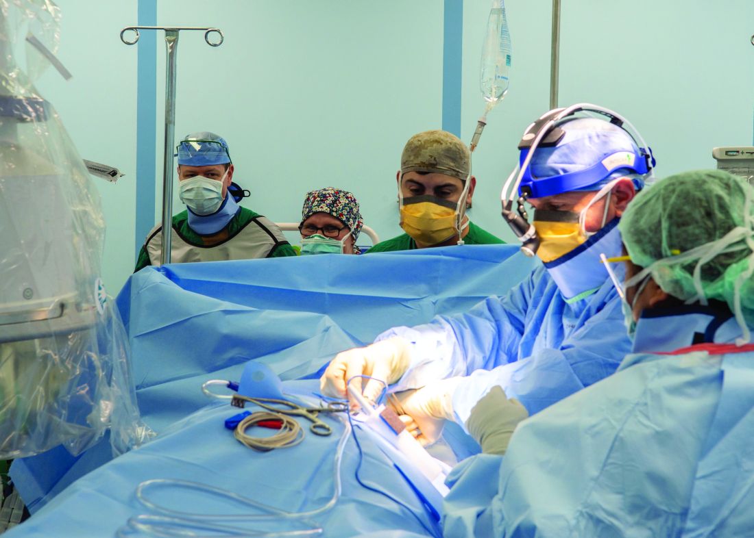 Capt. John Rotruck (left), USNS Mercy’s Medical Treatment Facility’s commanding officer, observes a pacemaker surgery aboard the ship on April 29.