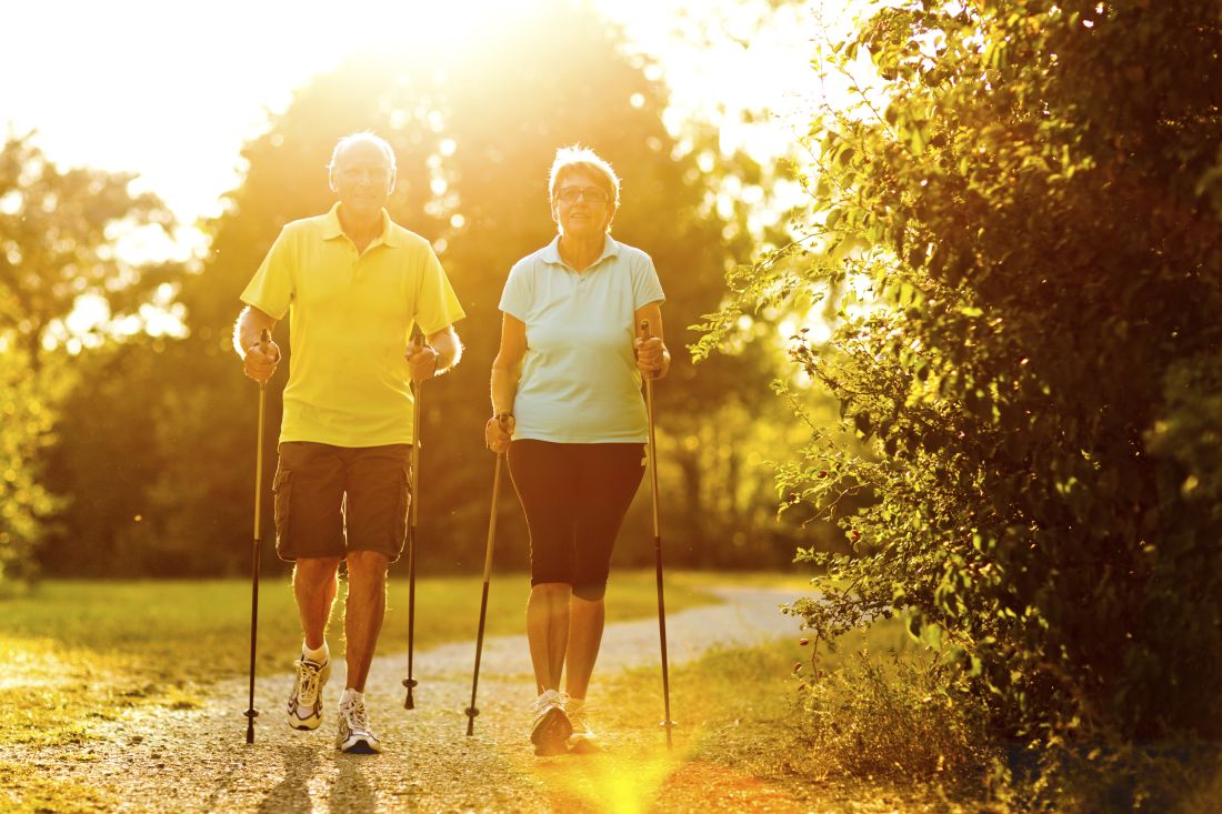 Two people do Nordic walking