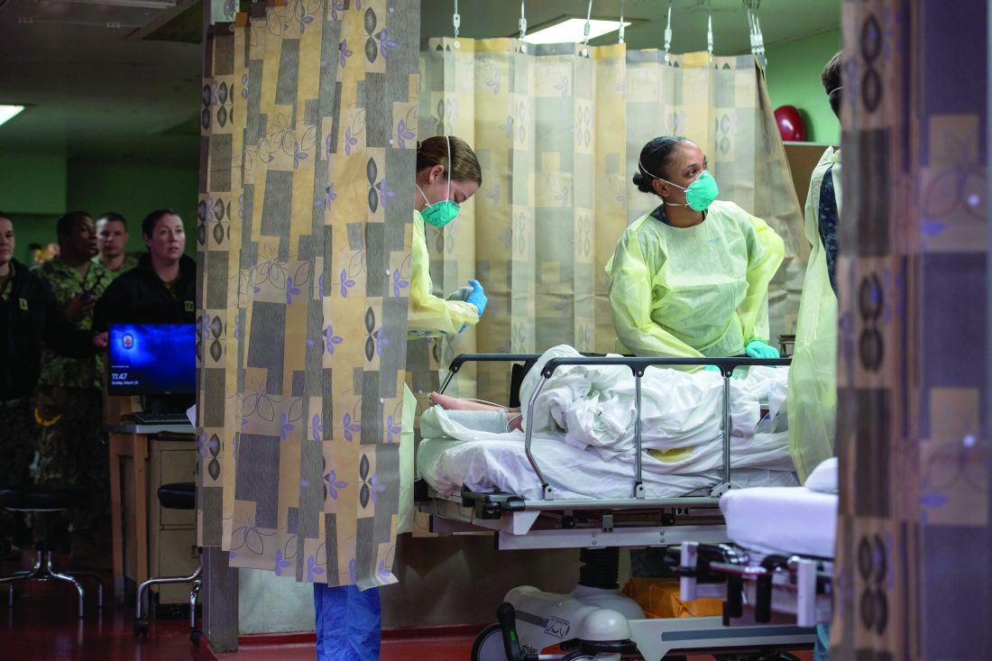 Sailors assigned to the hospital ship USNS Mercy treat a patient from Los Angeles medical facilities on March 29.