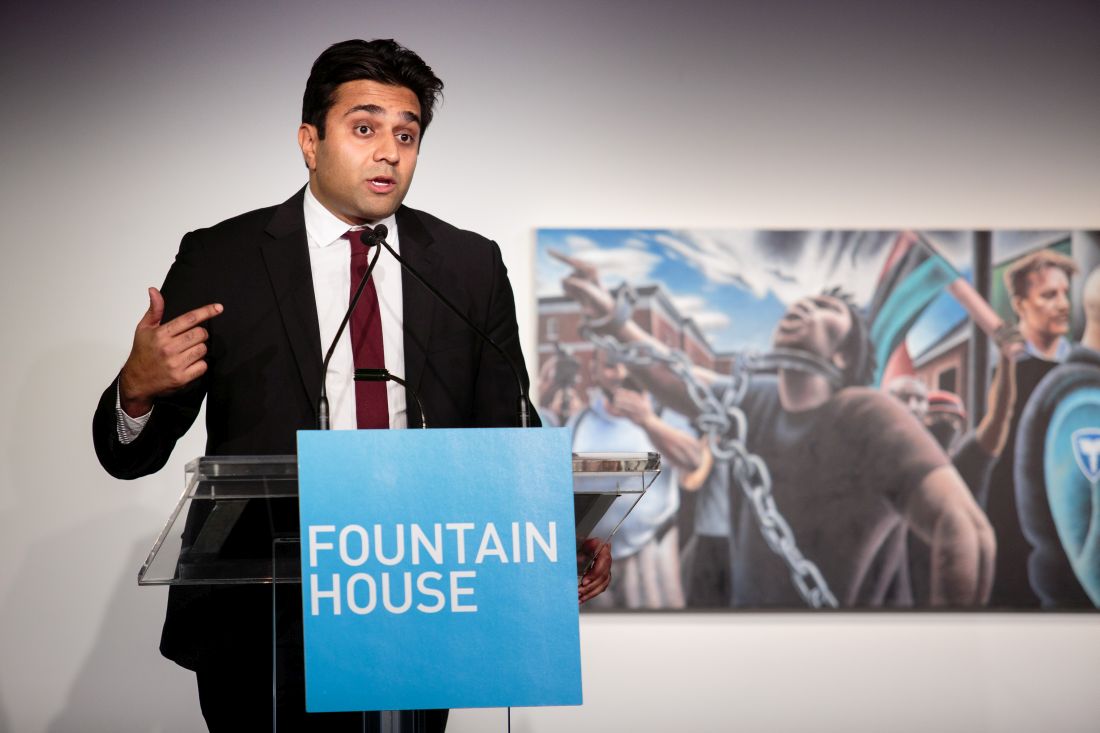 Dr. Ashwin Vasan addresses Fountain House supporters in late 2019 in front of artwork, &quot;Stand Up, 2019&quot; by Miguel Colón, Fountain House member and gallery artist.