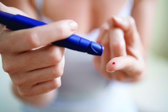 woman with diabetes testing blood sugar