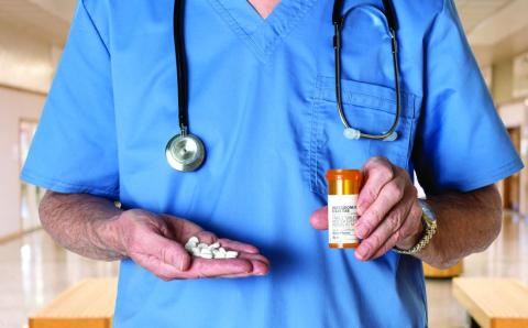 Generic oxycodone tablets in hands of doctor