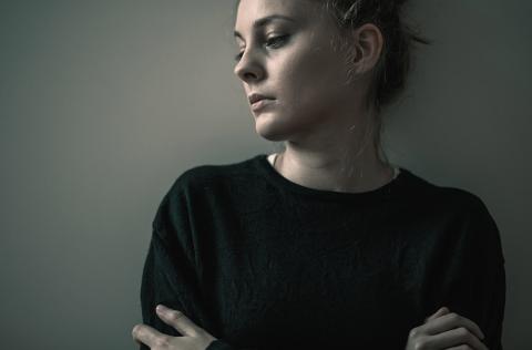Woman standing against wall