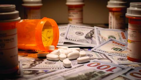 pill bottles and pills on money