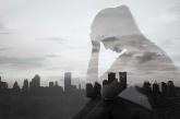 Woman holding her head in front of skyline