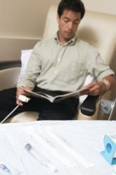 man sitting receiving chemotherapy