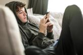 Boy on couch looking at cellphone Boy on couch looking at cellphone