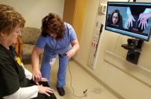 Dr. Christine Peoples (on screen), a UPMC rheumatologist, demonstrates how she uses telemedicine with staff members Kelly White, RN, and Cindy Buchanan, an administrative assistant. 