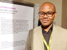 Dr David Asuzu stands before his poster presentation at the EAST surgery meeting.