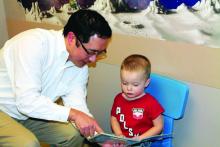 Dr. David Chung is shown during a well-child visit.