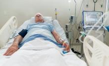 An elderly man in a hospital bed
