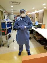 Dr. Keji Fagbemi, a hospitalist at BronxCare Health System in New York, wears PPE to treat COVID-19 patients.