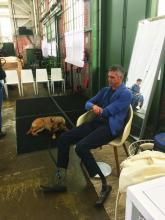 Dr. BJ Miller waits before a recent speaking event with his dog, Maysie.
