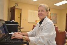 Nurse practitioner Julie Barnes enters data into St. Sampson Medical Clinic's electronic health record system.