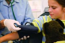 Child receiving blood pressure examination.