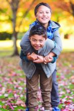 Two boys play outside