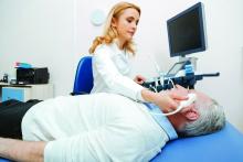 Female sonographer providing brain ultrasound in the hospital.