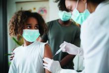 Young African American girl getting COVID-19 vaccine