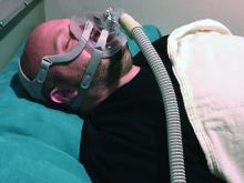 A man wears a CPAP device