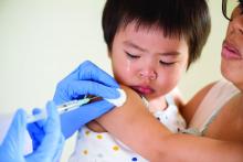 An Asian child is being vaccinated
