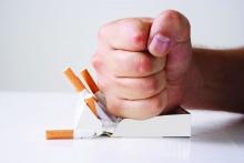 A fist smashing a pack of cigarettes is shown.