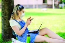 College student wearing mask outside