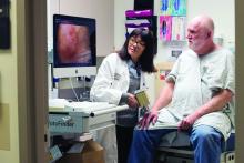 Washington University dermatologist Lynn Cornelius, MD,  conducts a skin exam with patient Robert Manchester, a participant in a clinical trial testing the effectiveness of a new topical immunotherapy for actinic keratoses.